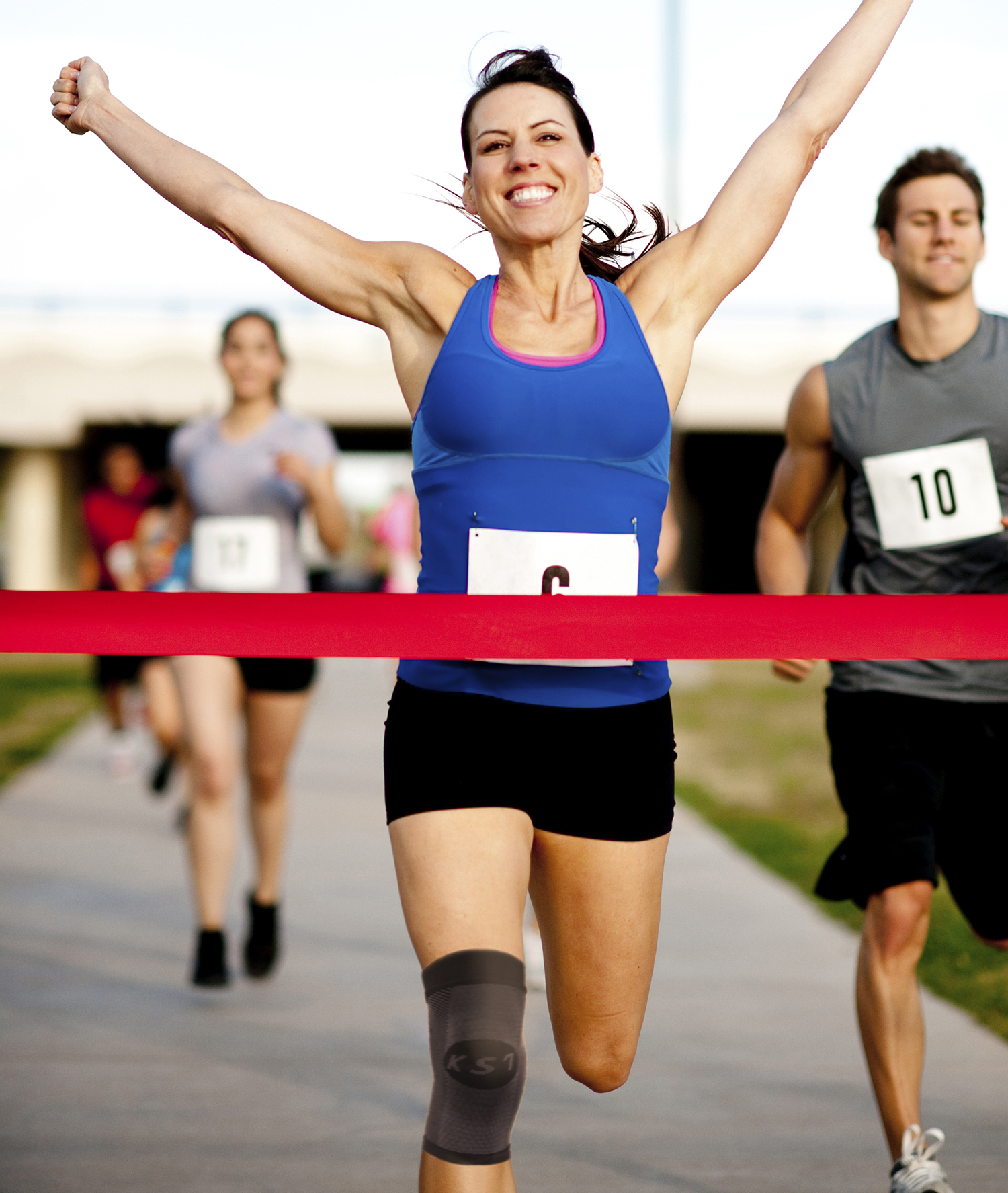 Woman running a marathon, cheering victory at the finish line.